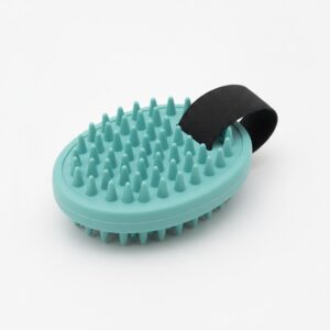 Teal silicone bath and massage brush with a hand strap on a white background